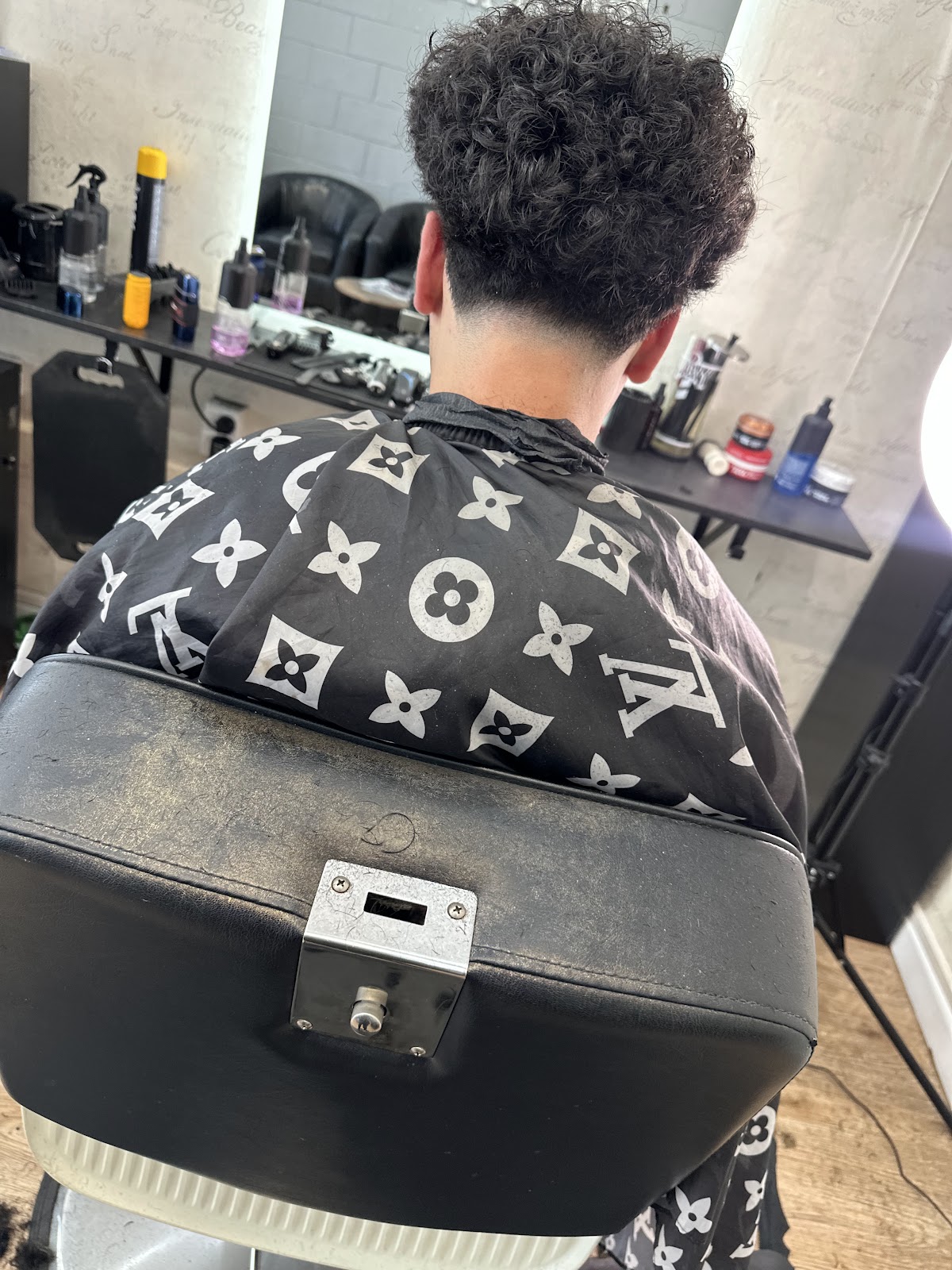Curly top haircut with a clean taper fade